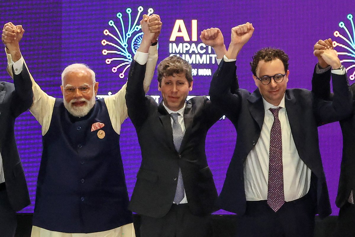 AI's top leaders got corralled into holding hands. It made for a photo op for the ages.