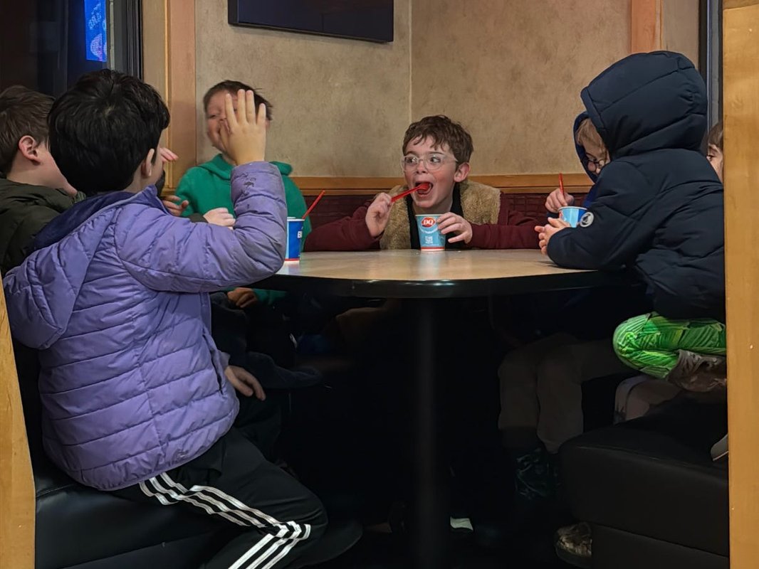 My 8-year-old invited his 4 best friends for dinner. I sat at a separate table and watched them have fun independently.