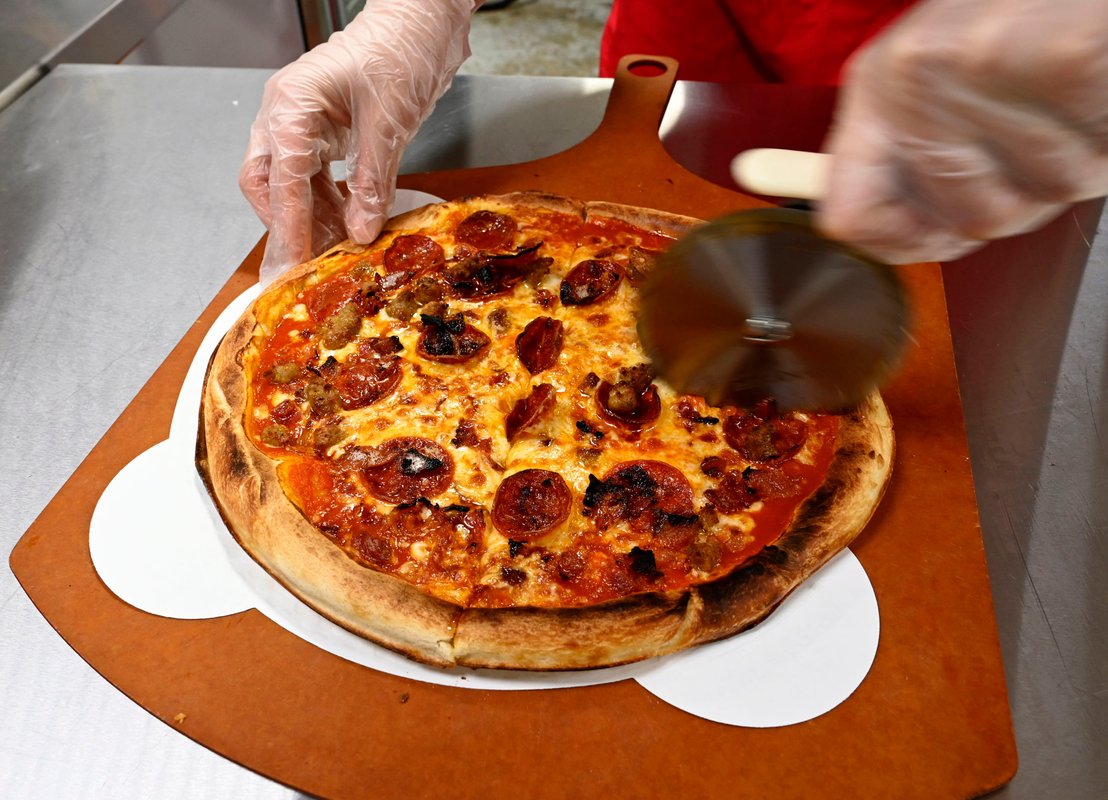 Elon Musk and OpenAI posture over pizza as the AI talent war heats up